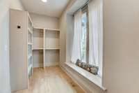 Not one but two owner suite closets with custom wood built-ins - irresistible natural lighting