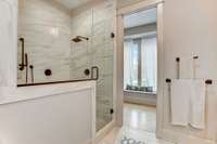 Dreamy walk in shower with bench and black European hardware