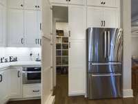 Walk-in pantry with hidden door.