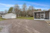 View of the back area from far left side of house.  You have lots of room for parking for everyone visiting.  Plus room to work outside the workshop/garage 20' x 20' Previous owner was a woodworker.