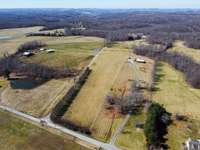 Additional drone photos of the property coming from Shangri Lane, with the Bradford Pears in front (L shaped) and the home in the far rear.