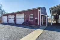 A man's dream....or a female (you decide). 3 bay 40x60x12 Metal building with an office, bathroom, concrete flooring, 200amp service, window A/C, florescent lighting, security system, storage room, with attached 30x50x12 pull through garage.