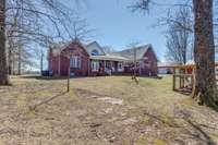 From the treed backyard, get a look at the back of the home. with an extra large covered back porch; fenced for your 2 and 4 legged friends and a chicken coop if you are into it. Perfection all on 41 acres.