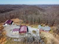 See the 40x100x14 to the far left, home to the far right.  The 3 bay garage (in the middle) has an office, bathroom, 3 bays, Air & tile floors in the office, w/200amp svc, 2 man doors, concrete floors & a 50'x17.5'x14' awning for a motor home.