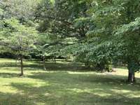 A great shot of the shade trees and beautiful grounds awaiting you here. Better than any park and it can all be yours.