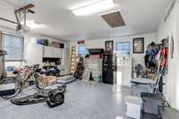 Garage floor with epoxy coatings. All shelving and cabinets convey.