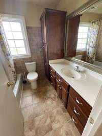 Bathroom combo tub and shower with lots of cabinets!