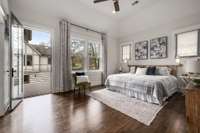 Beautiful primary bedroom with private balcony overlooking the back yard