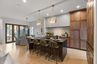 An expansive waterfall island anchors this modern and spacious kitchen design.