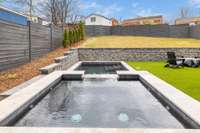 Spa and pool designed and installed by New Beginnings Landscapes with night lighting and party settings.