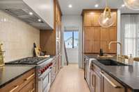 Hidden pantry with a view filled with storage top to bottom with sliding ladder access for custom cabinetry from floor to ceiling.