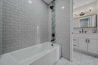 Make a statement with a unique yet classic tile design in the shower and a more subtle pattern on on the floors + a Soaking Tub!!