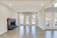 NEW Solid White Oak hardwood floors with a wood burning fireplace.