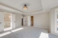 Primary Bedroom  The Tray ceiling screams style. Make a statement with this luxe pendant chandelier.