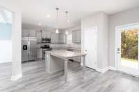 Modern Kitchen with Grey Cabinets and Granite Countertops, look at the size of that island!