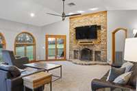 Floor to ceiling stacked brick wood burning fireplace