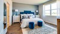 Main bedroom has double windows for lots of natural light! For reference, the bed in the picture is a king bed and still leaves plenty of room for wide side tables! Pictures are of previously completed home of same floorplan. Features may vary.