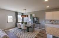 Model / Inspirational Photo: Ample space in the Dining Area, convenient to the Kitchen and the Gathering Room.
