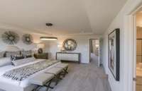 Model / Inspirational Photo: Primary Bedroom Suite upstairs is spacious and optional tray ceiling is shown.