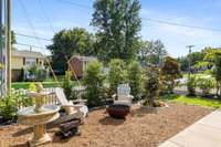 Thoughtful landscaping surrounds the space, incorporating a variety of plants and greenery that complement the home's style.