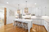 Custom cabinetry lines the walls, providing both functionality and a touch of timeless elegance. The cabinetry, thoughtfully designed and expertly crafted, offers ample storage space while contributing to the kitchen's aesthetic appeal.