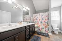 The primary bathroom is so large and features a dual vanity, soaking tub, and a generous walk-in closet!