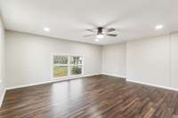 Enormous primary master bedroom. The additional corner beside the brick could easily be framed in for additional closet space of custom built-ins. Left for new owners' discretion.