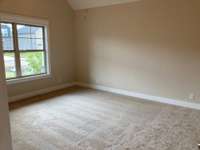 Stock photo of owner's suite with vaulted ceiling