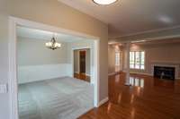 From the front entrance, you're welcomed with a spacious formal dining room to your left, and a large sunken living room with a fireplace and beautiful hard wood floors straight ahead.