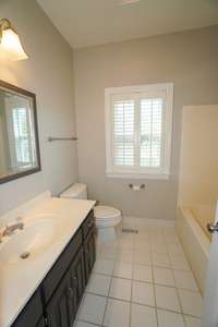 Just past the kitchen is the first full bathroom. Plenty of counter and cabinet space around the sink, and a tub/shower combo.