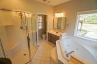 Your en suite primary bathroom features a large stand up shower, jet tub, double separate vanities, and a private water closet!