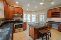 This view of your kitchen features the built in desk, which is just beside the pantry. The eat in portion has access to laundry room, sunroom, and living room! The flow is awesome!