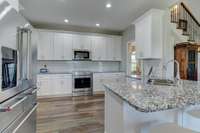 The kitchen seamlessly flows into the main living space, ensuring the chef remains connected to the activity of the home.