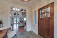 View from the entry foyer through the living to the beautiful pool beyond.