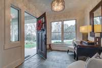 Foyer is a generous welcoming size with slate tiled floor and beautiful chandelier.