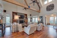 Gotta love those walnut floors and built-ins, also the rustic touch overhead!