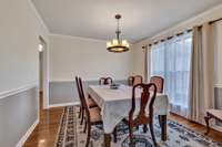 Step into elegance with the formal dining room featuring an exquisite overhead fixture, large windows filling the space with natural light, and charming crown molding! S209 Fieldstone Dr.   Murfreesboro, TN 37127