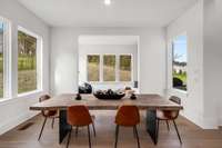 Dining table next to the kitchen area that leads to the sunroom overlooking the backyard.