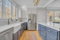 Farmhouse sink and hardwood floors.