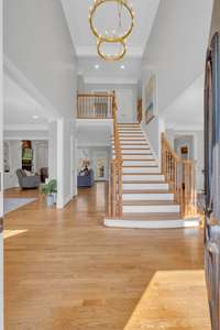 Upon entry, guests are greeted by a two story, formal foyer with a spacious living room and stylish dining room on each side.