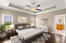 On the main floor, the primary BR Suite is warm and inviting!  A trey ceiling, crown molding and neutral paint colors create a palette suitable for your specific tastes. Rich, sand/finish hardwoods bring opulence to this room. (virtually staged)