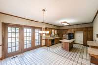 Tile flooring and large kitchen with patio dining