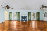 The living room is oversized and has beautiful wood floors.