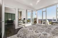 Custom-designed mirrors specifically fitted to this space enhance the already abundant natural light and reflect the cityscape below. Motorized shades in the bedroom offer easy control over privacy and light levels.