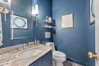 This powder room is conveniently located just between the kitchen and the hallway to garage.