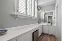 The vanity area from bedroom #2 that leads into the closet as well as the water closet/tub/shower area.