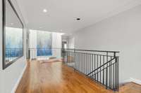 The upstairs used to have carpet and a wooden banister, but when the current owners renovated, they added hardwood floors and custom black iron railing...love it!