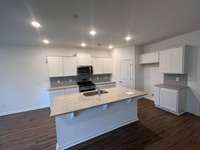 The kitchen will include white cabinetry, granite countertops, stainless steel appliances and a subway tile backsplash.