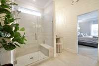 Large walk in shower that has a stunning look. The tile is attractive and there is a built in bench.