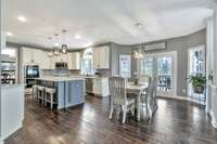 Double doors off the kitchen lead to a fantastic porch.  Breakfast nook area leads to the great room.  This house has a beautiful flow all overlooking the spacious backyard.